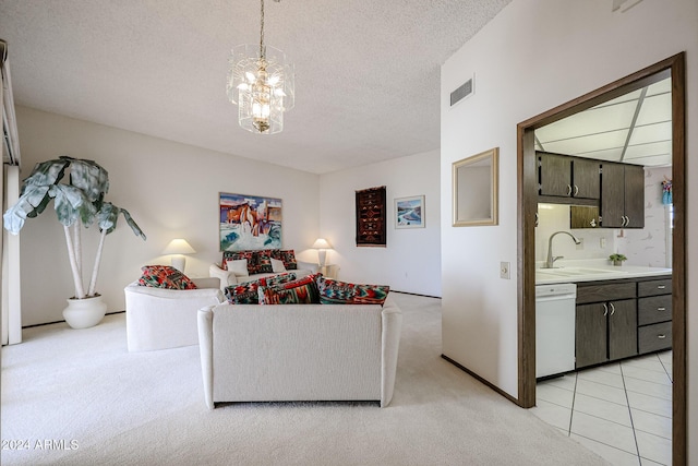 carpeted living room featuring a textured ceiling, a notable chandelier, and sink