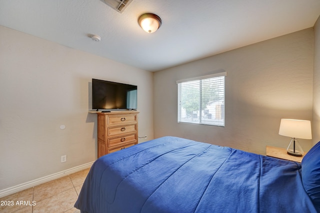 bedroom with light tile patterned floors