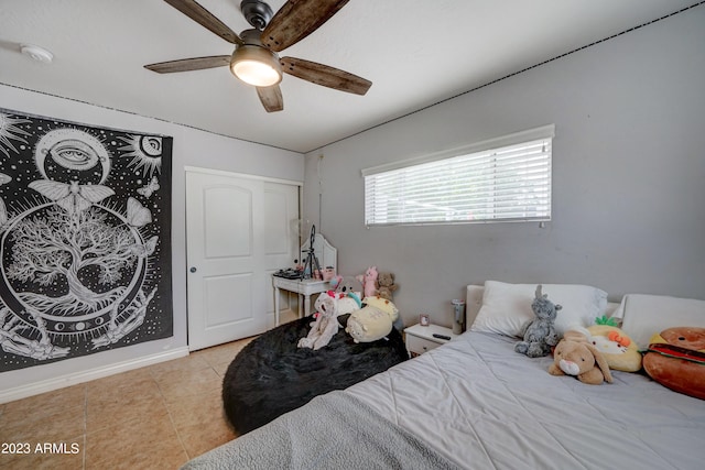 tiled bedroom featuring ceiling fan