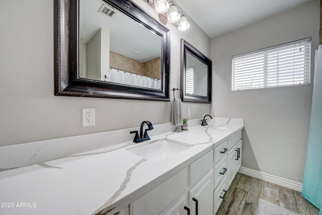 bathroom with vanity, hardwood / wood-style flooring, and walk in shower