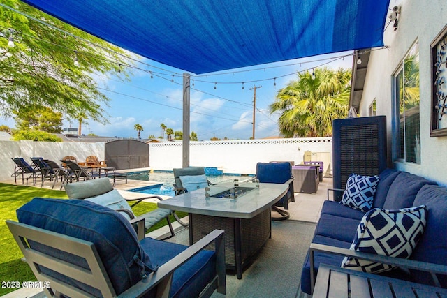 view of patio featuring an outdoor hangout area, a shed, and a fenced in pool