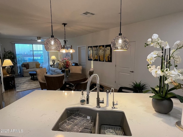 kitchen featuring sink, pendant lighting, and hardwood / wood-style floors