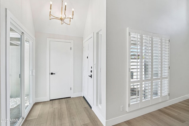 6629 N Majorca Way E, Phoenix, AZ 85016 - entryway with a chandelier, wood finished floors, lofted ceiling, and baseboards