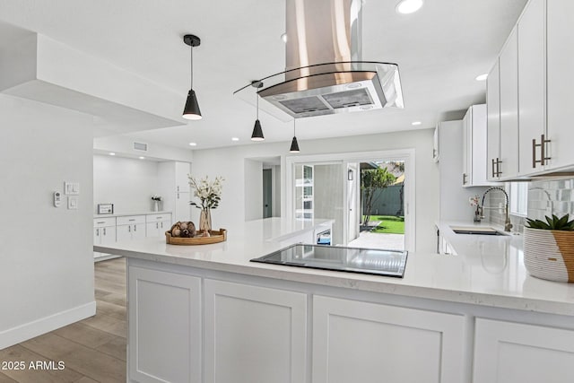 6629 N Majorca Way E, Phoenix, AZ 85016 - kitchen featuring island exhaust hood, black electric cooktop, a sink, white cabinets, and light wood-style flooring