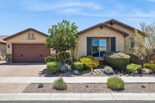 33305 N 26th Ave, Phoenix, AZ 85085 - view of front of home featuring stucco siding, an attached garage, decorative driveway, a tile roof, and stone siding