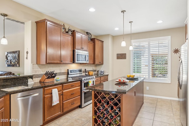 33305 N 26th Ave, Phoenix, AZ 85085 - kitchen featuring appliances with stainless steel finishes, backsplash, brown cabinetry, light tile patterned floors, and recessed lighting