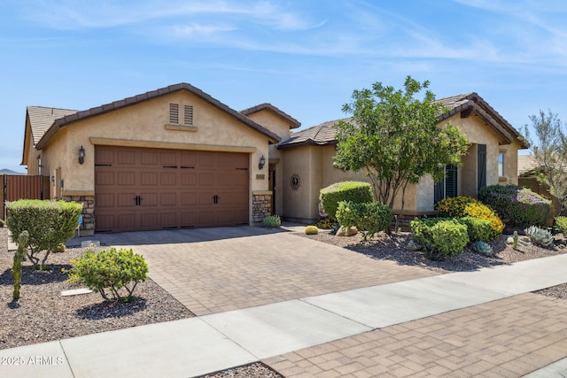 33305 N 26th Ave, Phoenix, AZ 85085 - single story home with an attached garage, stucco siding, decorative driveway, stone siding, and a tile roof