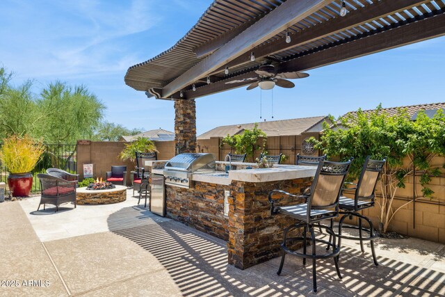 33305 N 26th Ave, Phoenix, AZ 85085 - fenced backyard with an outdoor fire pit, exterior bar, an outdoor kitchen, a patio area, and ceiling fan