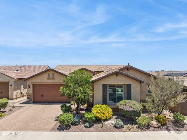 33305 N 26th Ave, Phoenix, AZ 85085 - view of front of home featuring stucco siding, decorative driveway, an attached garage, and a tiled roof