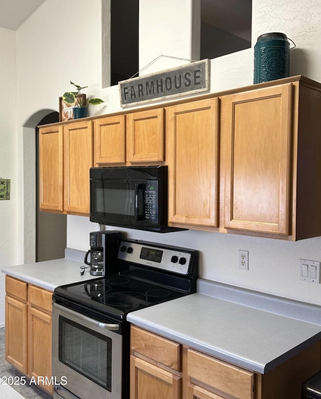 kitchen with stainless steel range with electric cooktop