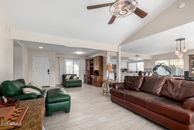 living room featuring lofted ceiling, light wood-type flooring, and ceiling fan