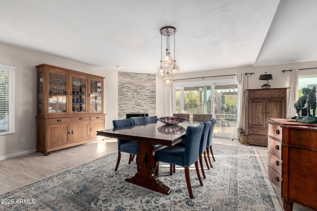 dining room featuring a stone fireplace