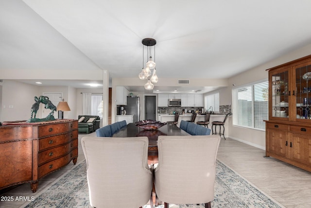 dining space with light hardwood / wood-style flooring