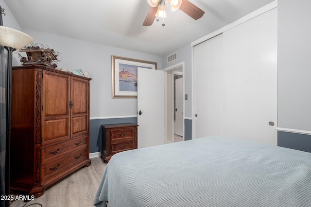 bedroom featuring light hardwood / wood-style floors, a closet, and ceiling fan