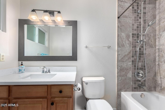 full bathroom featuring tiled shower / bath combo, vanity, and toilet