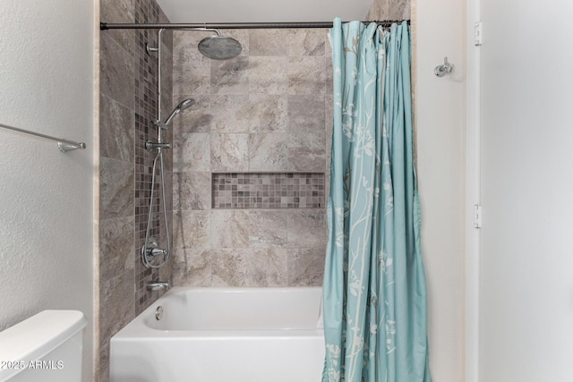 bathroom featuring shower / tub combo with curtain and toilet