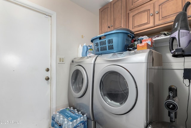 laundry room featuring cabinets and washer and dryer