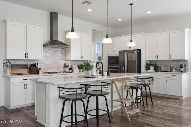 20510 W White Rock Rd, Buckeye, AZ 85396 - kitchen featuring wall chimney exhaust hood, a center island with sink, backsplash, white cabinets, and recessed lighting