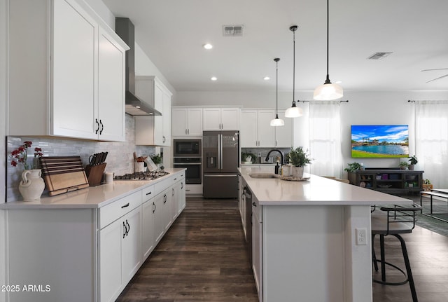 20510 W White Rock Rd, Buckeye, AZ 85396 - kitchen featuring appliances with stainless steel finishes, a sink, wall chimney exhaust hood, decorative backsplash, and white cabinetry