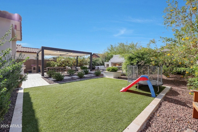 20510 W White Rock Rd, Buckeye, AZ 85396 - view of green lawn featuring a lit fireplace, a patio, and a trampoline