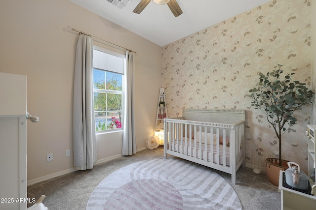 20510 W White Rock Rd, Buckeye, AZ 85396 - bedroom featuring wallpapered walls, carpet, a crib, baseboards, and a ceiling fan