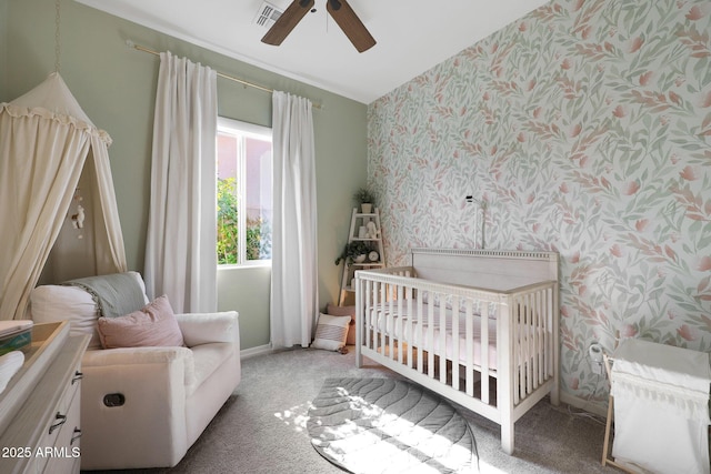 20510 W White Rock Rd, Buckeye, AZ 85396 - carpeted bedroom with wallpapered walls, a crib, and ceiling fan