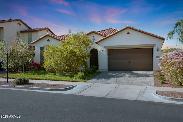 20510 W White Rock Rd, Buckeye, AZ 85396 - mediterranean / spanish house featuring stucco siding, decorative driveway, a garage, and a tile roof