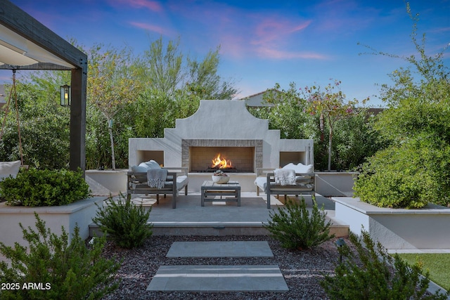 20510 W White Rock Rd, Buckeye, AZ 85396 - patio terrace at dusk with an outdoor living space with a fireplace and a patio area