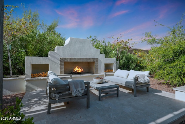 20510 W White Rock Rd, Buckeye, AZ 85396 - patio terrace at dusk featuring a patio and an outdoor living space with a fireplace