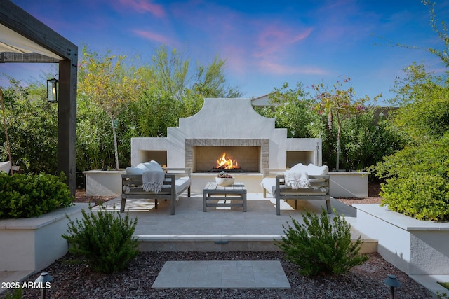 20510 W White Rock Rd, Buckeye, AZ 85396 - patio terrace at dusk with a patio and an outdoor living space with a fireplace
