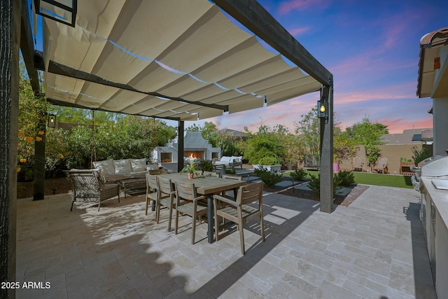 20510 W White Rock Rd, Buckeye, AZ 85396 - patio terrace at dusk with an outdoor living space with a fireplace, a patio, outdoor dining area, a fenced backyard, and a pergola