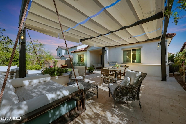 20510 W White Rock Rd, Buckeye, AZ 85396 - patio terrace at dusk featuring an outdoor hangout area, outdoor dining area, and a patio area