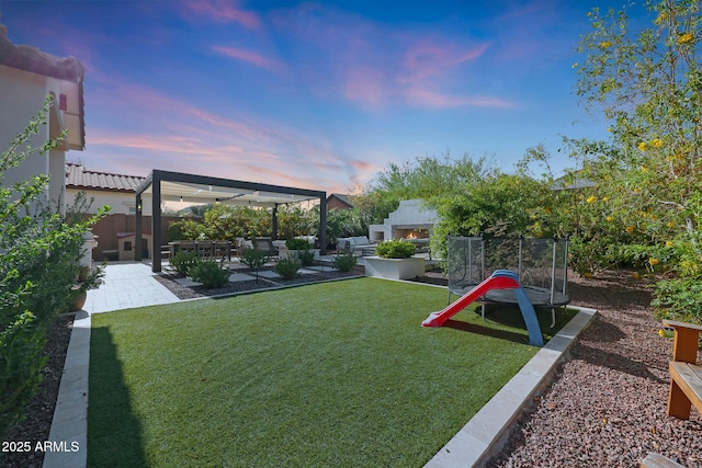 20510 W White Rock Rd, Buckeye, AZ 85396 - view of yard featuring a warm lit fireplace and a patio