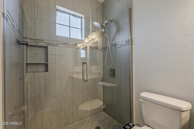 full bath with a shower stall and toilet
