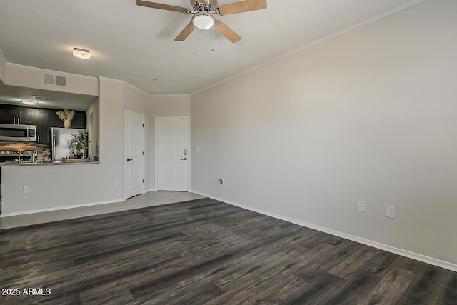 unfurnished living room featuring a ceiling fan, baseboards, visible vents, and dark wood finished floors