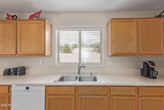 kitchen with a sink, light countertops, and dishwasher