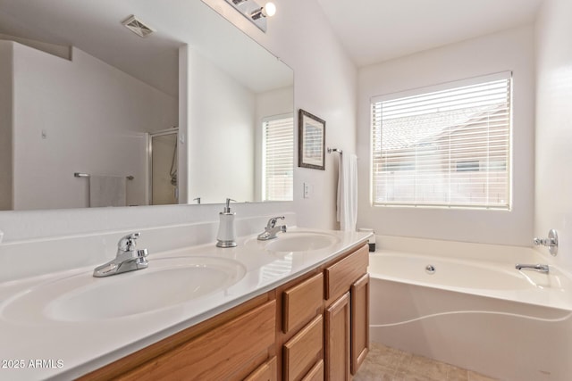 bathroom with a sink, a stall shower, a garden tub, and visible vents