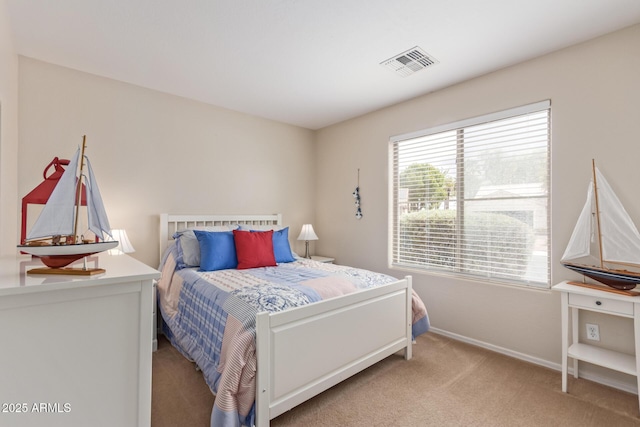 bedroom with baseboards, light colored carpet, and visible vents