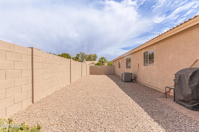view of yard featuring cooling unit and a fenced backyard