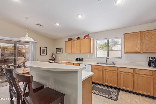 kitchen featuring light countertops, lofted ceiling, a sink, visible vents, and white dishwasher
