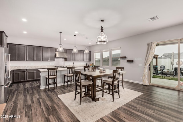 dining space featuring dark wood finished floors, visible vents, recessed lighting, and baseboards