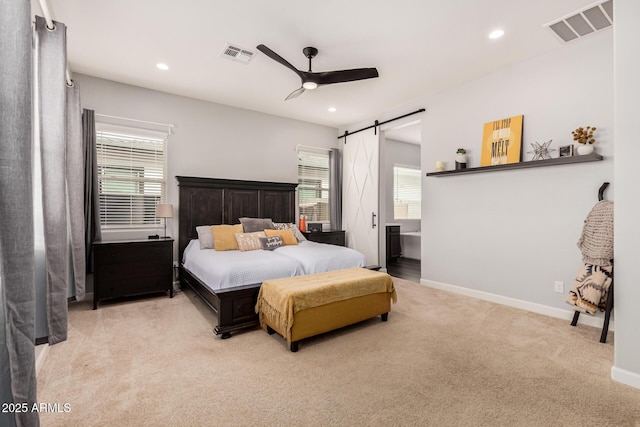 bedroom featuring a barn door, carpet flooring, recessed lighting, and visible vents