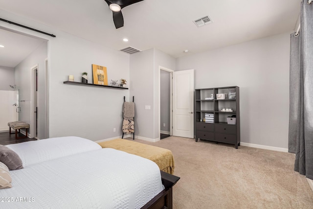 bedroom with baseboards, visible vents, and light carpet