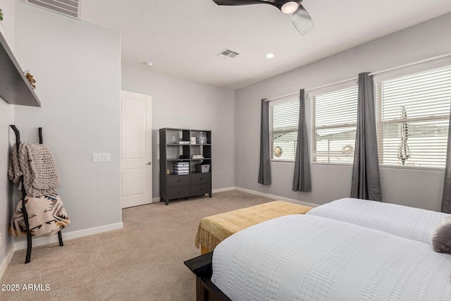 bedroom with visible vents, light carpet, baseboards, and a ceiling fan