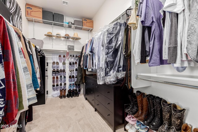 spacious closet with carpet flooring and visible vents