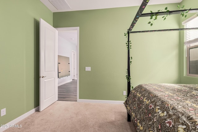 bedroom featuring visible vents, baseboards, and carpet