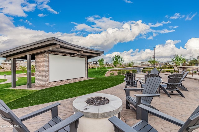 view of patio featuring an outdoor structure and an outdoor fire pit