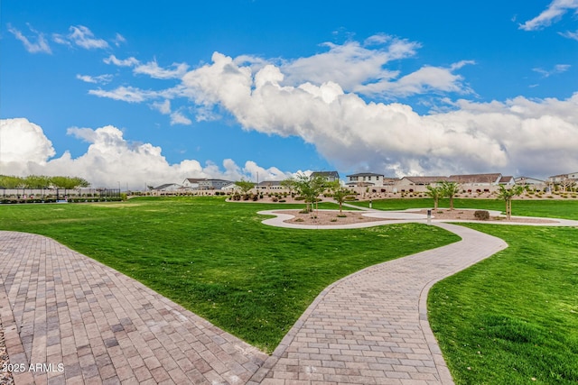 view of home's community with a yard