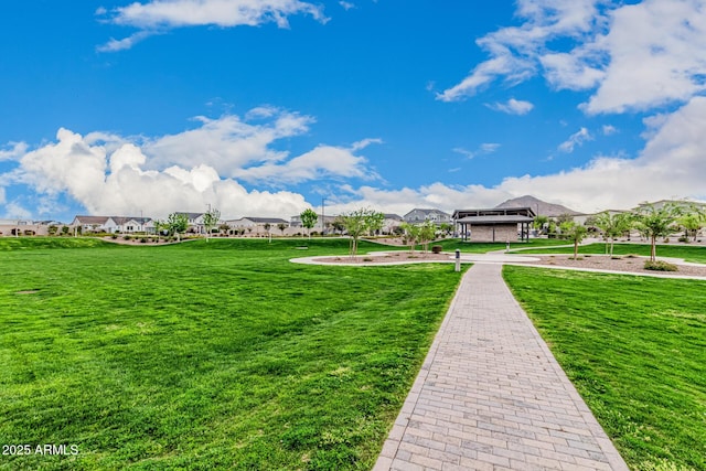 view of home's community featuring a residential view and a lawn