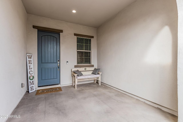 view of exterior entry featuring stucco siding